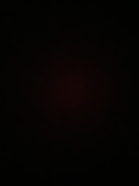 a black background with a red light in the middle